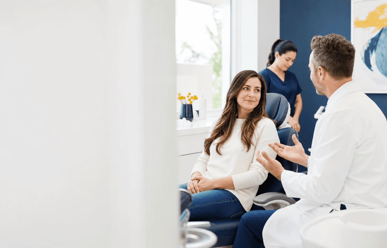 Brightly Dental dentist explaining same-day emergency dental options to a patient